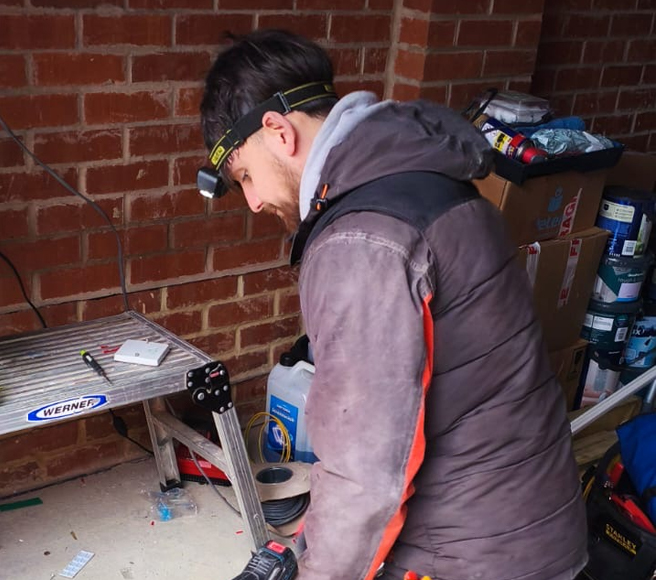 Electrician inspecting a consumer unit